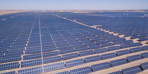 Solar panels in a desert terrain are watched for performance by GE's APM software